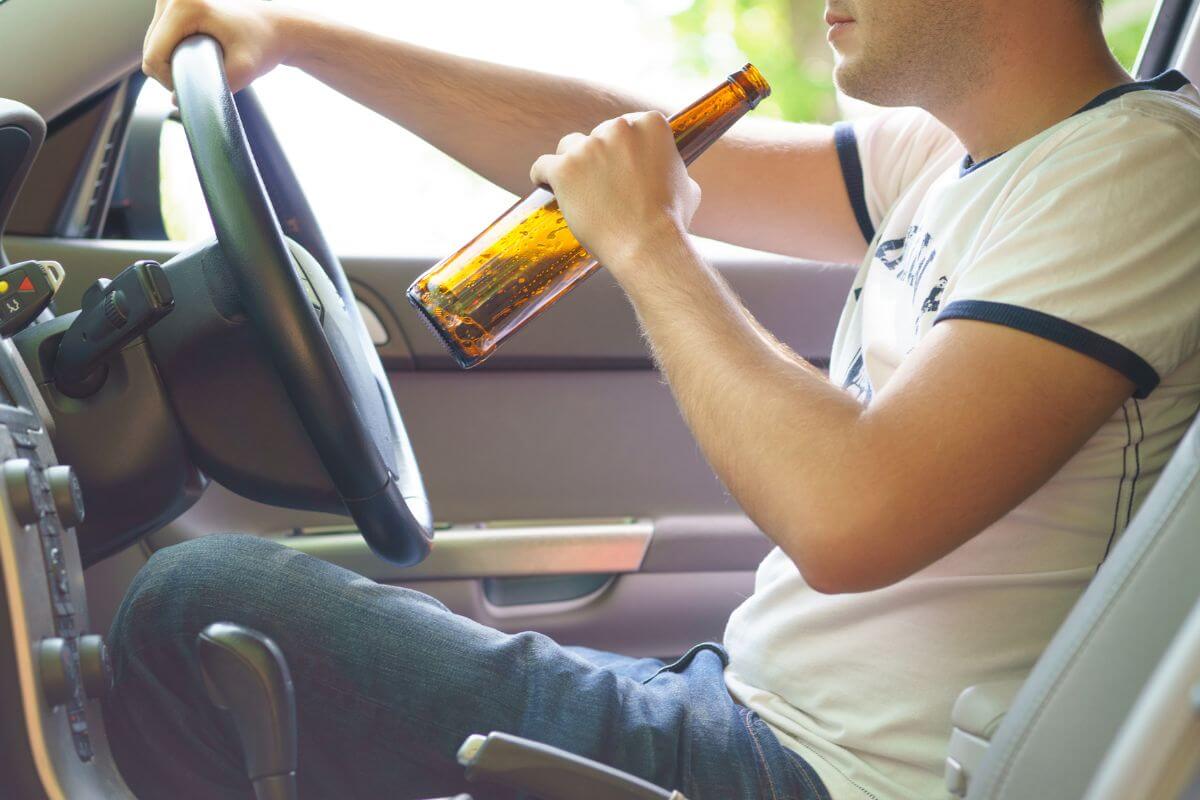 Man in White Shirt Drinking Beer While Driving in Montana
