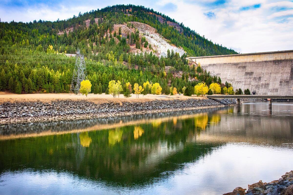 A dam surrounded by trees and mountains, located in Libby Montana.