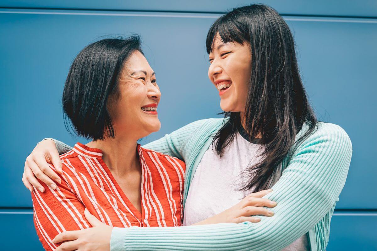 Two Asian women in Montana embracing each other.