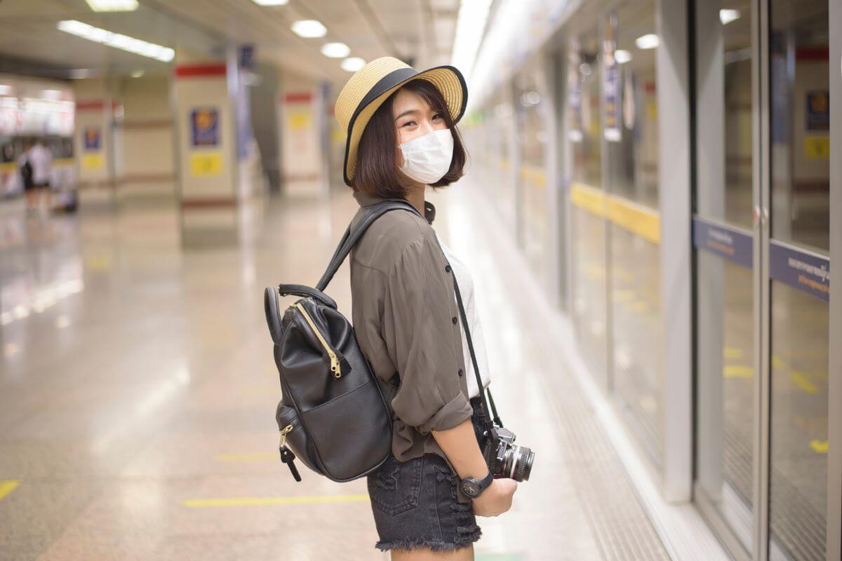 A woman wears a face mask in a subway station.