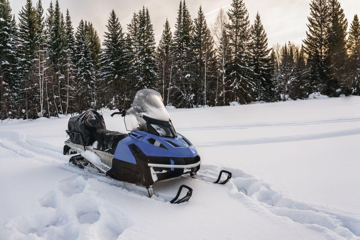 A blue snowmobile in a snowy area in Montana.