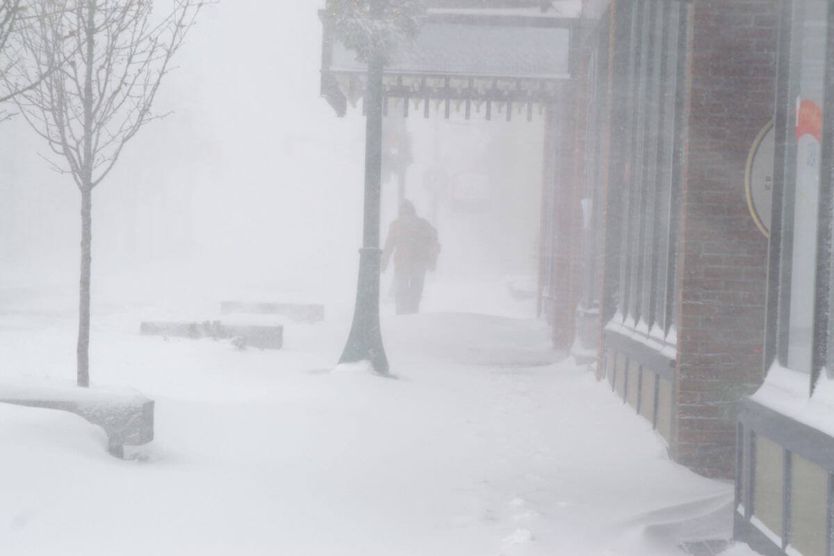 A person walks down a deserted street during a snow storm in Montana.