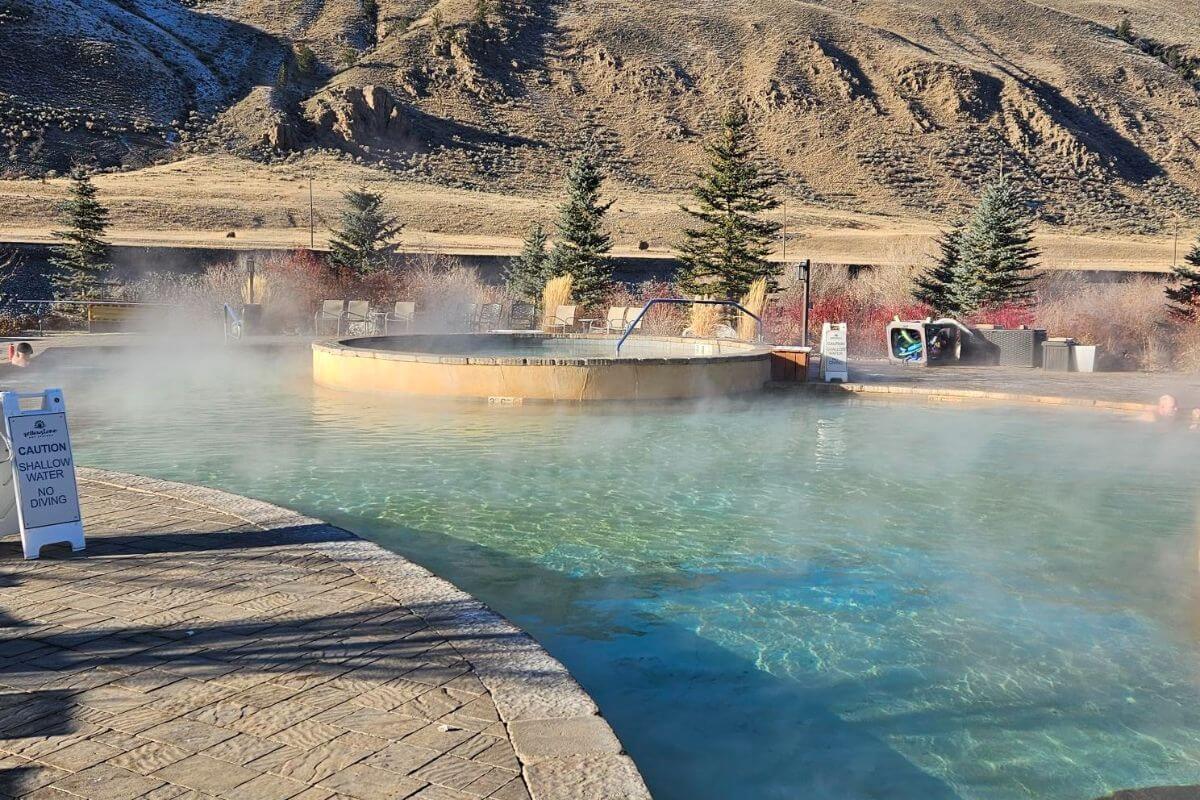 A steaming hot tub built into a larger pool at Yellowstone Hot Springs 