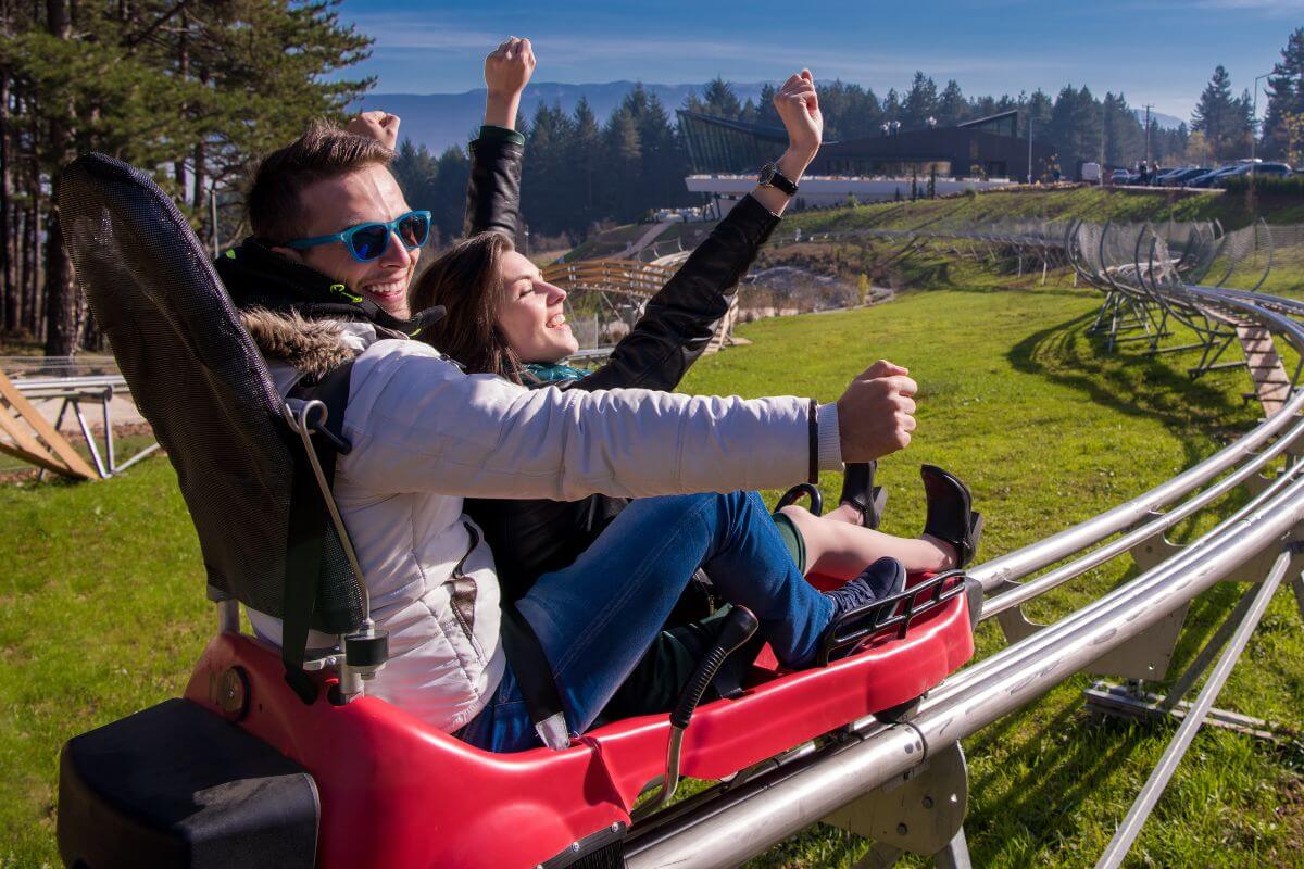 A couple enjoy a ride in Montana's only mountain coaster, Flathead Lake Alpine Coaster.